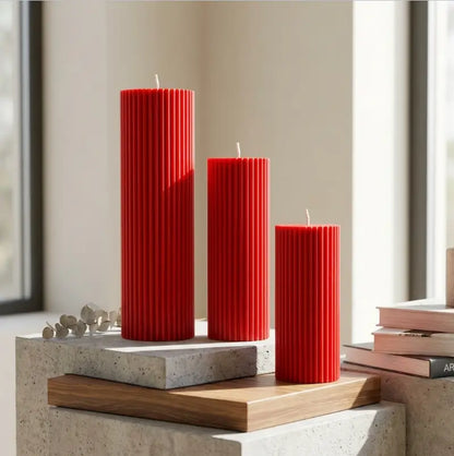 Ribbed Candles - Set of 3 Pillars in red, showcasing varying heights and vertical ribbing for decorative displays.