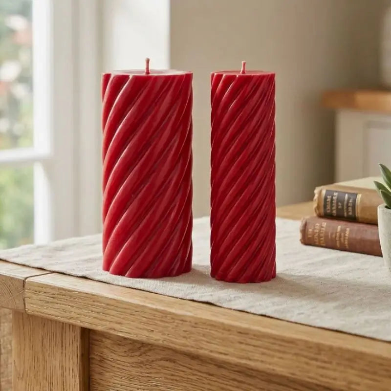 Pillar Candle Set featuring two spiral columns in red, one broad and sculptural, the other slimmer, perfect for any table centerpiece.