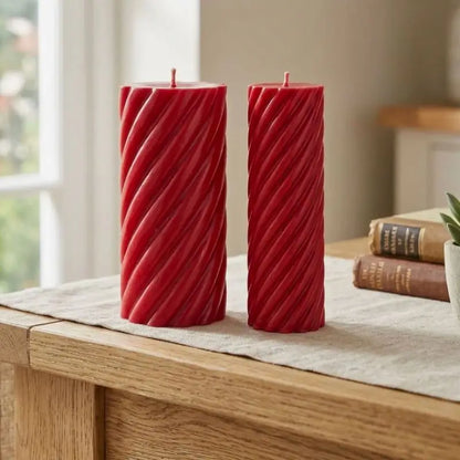 Pillar Candle Set featuring two spiral columns in red, one broad and sculptural, the other slimmer, perfect for any table centerpiece.