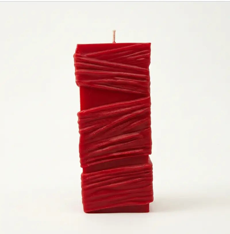 Custom Candle in large sculptural design, hand-poured in vibrant red color, featuring a unique textured surface.