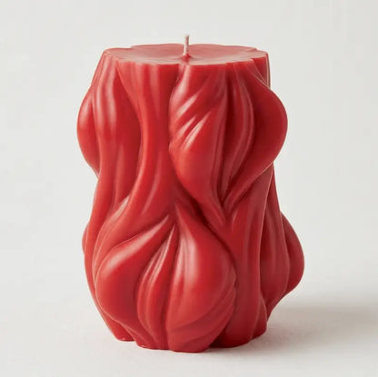 Decorative Candle in red with unique curved design, ideal for home decor and creating ambiance.