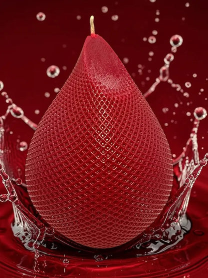 Water Drop Candle with geometric lattice design in deep red, surrounded by splashing water for a modern aesthetic.