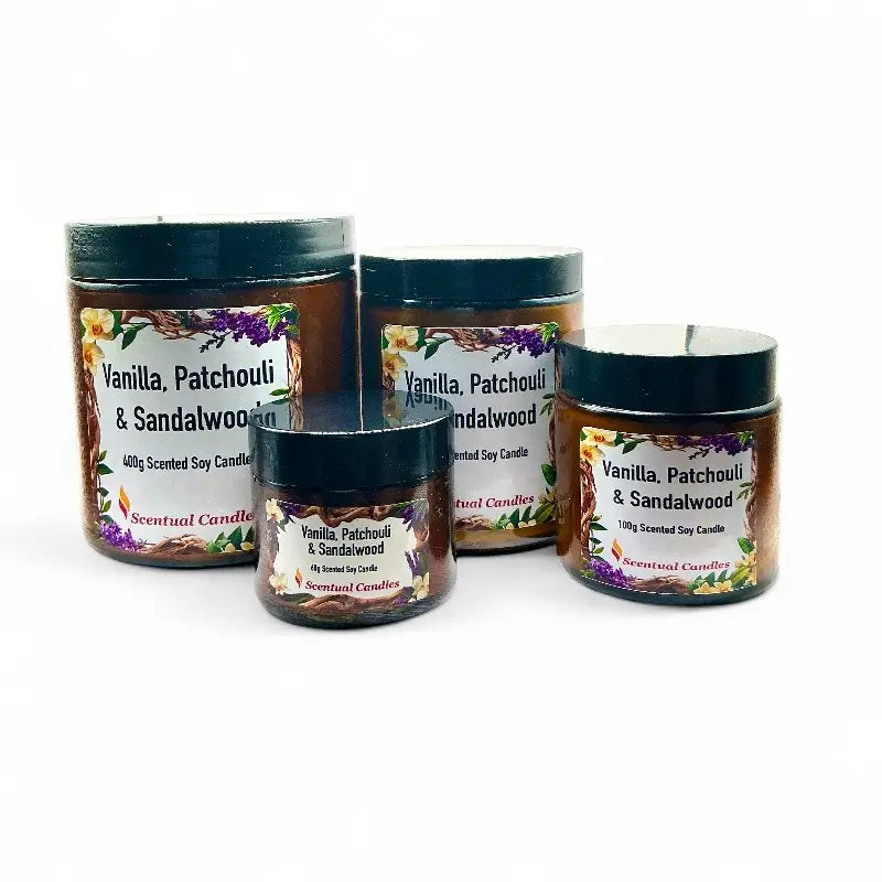 Four scented candles labeled Vanilla Patchouli and Sandalwood on a white background