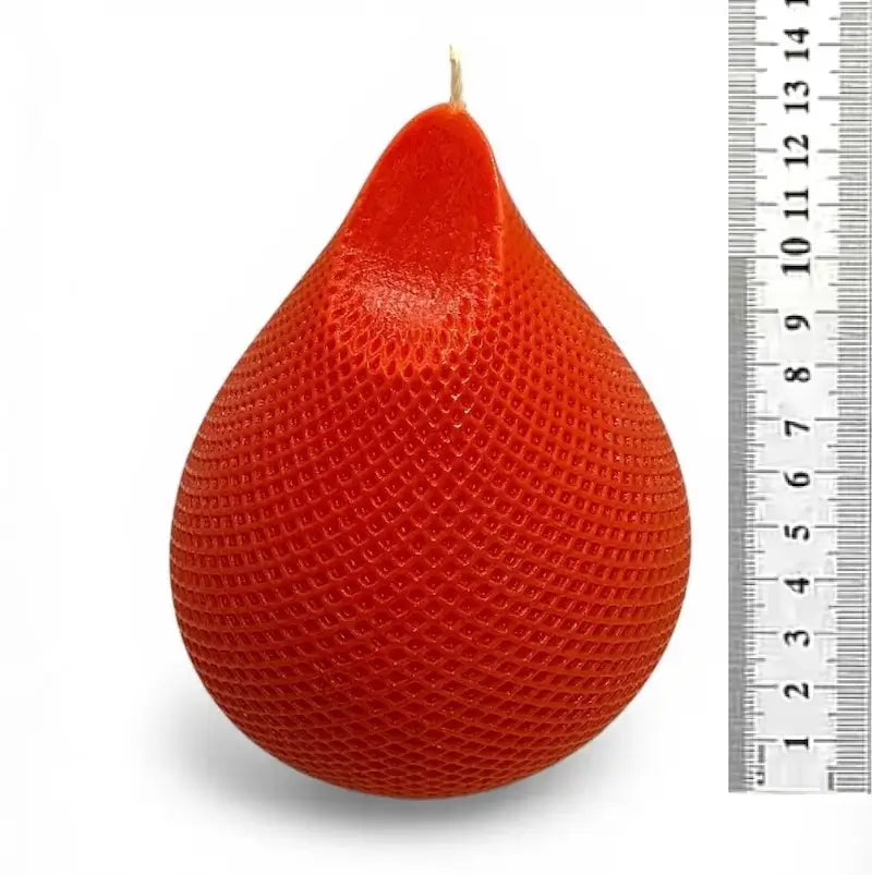Water Drop Candle in a red teardrop shape with textured surface next to a ruler for size comparison.