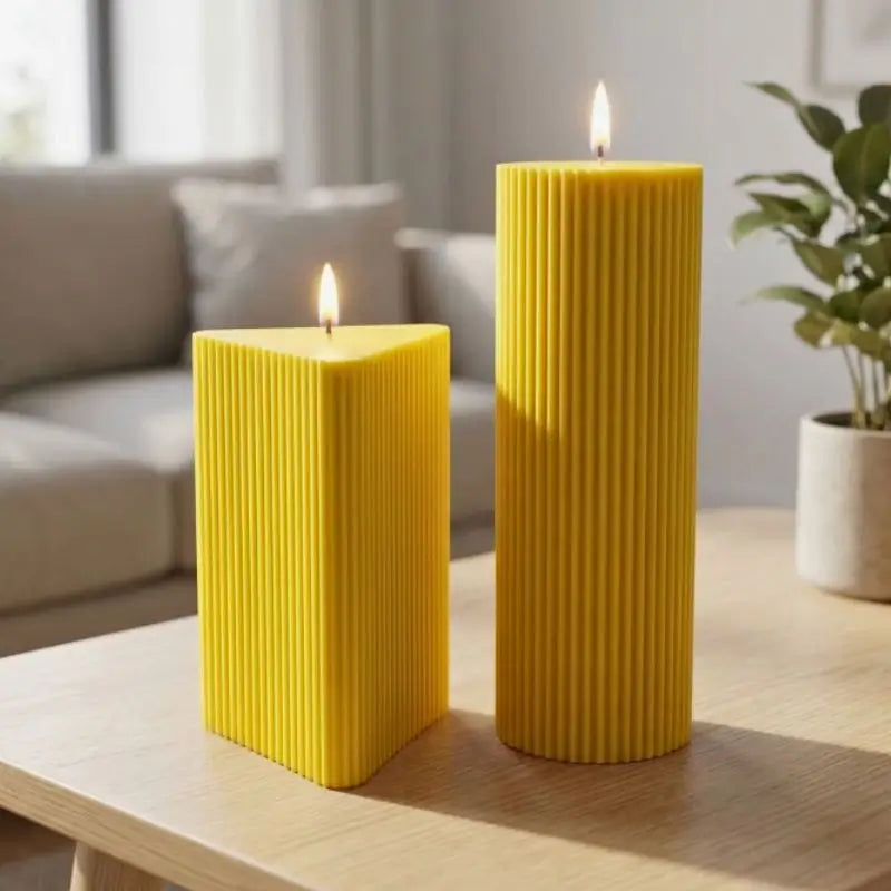 Geometric Pillar Candle set featuring yellow ribbed triangle and column displayed in a modern living room.
