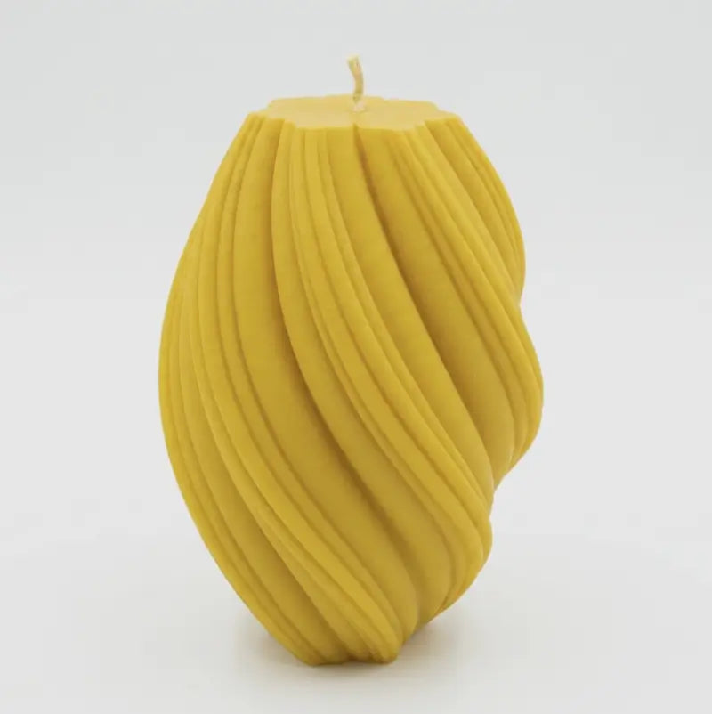Large Pillar Candle in a swirly shape, handcrafted with a vibrant yellow color and unique sculptural design.