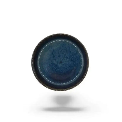 Blue ceramic candle holder plate on a white background