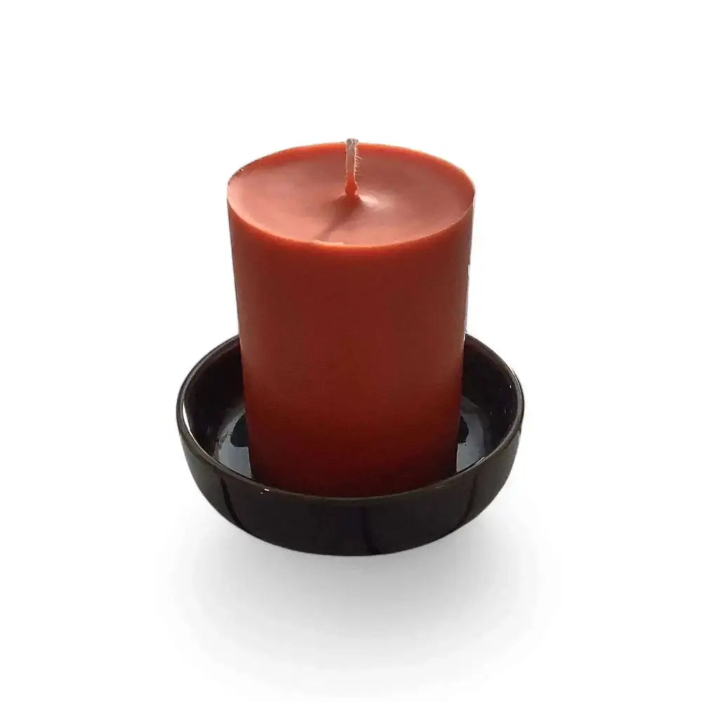 Ceramic Candle Holder Plate 9cm in black with a red candle displayed.