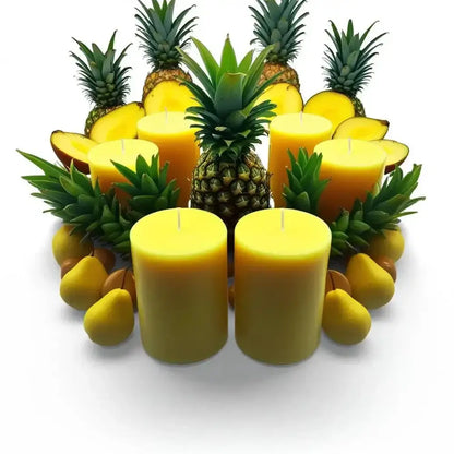 Fruit Scented Soy Candle Set surrounded by fresh pineapple and mango.