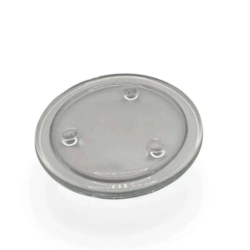 Round transparent glass candle holder plate with small feet for stability and heatproof design.