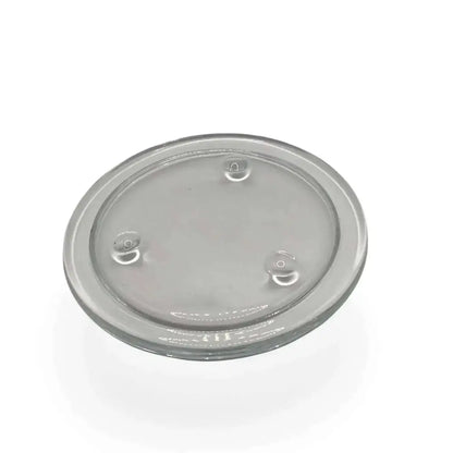 Round transparent glass candle holder plate with small feet for stability and heatproof design.