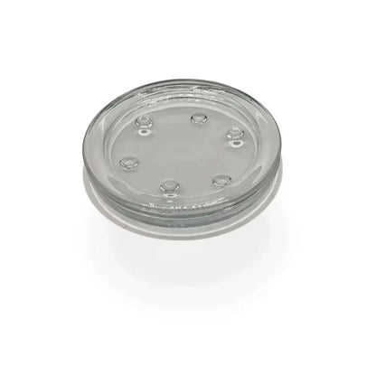 Round transparent glass candle holder plate with small feet for stability, 10cm diameter, heatproof and versatile for various candles.
