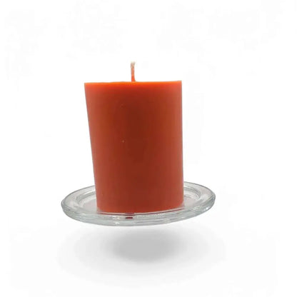Transparent glass candle holder plate with orange candle, 10cm diameter, heatproof base.