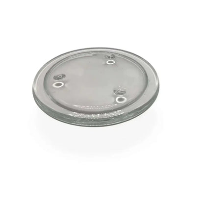 Round transparent glass candle holder plate with small feet for stability and heat protection.