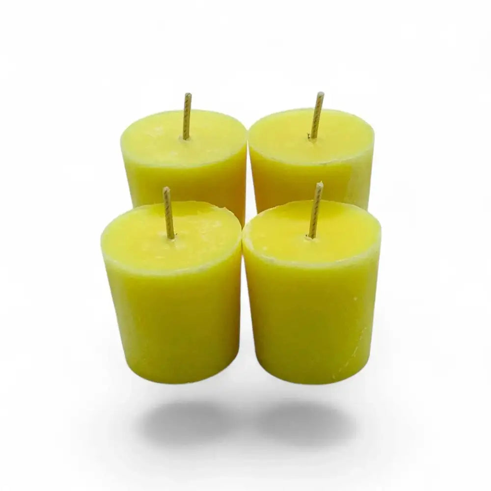 Jasmine scented soy votive candles glowing in a set of four, crafted from premium coconut/soy wax blend.