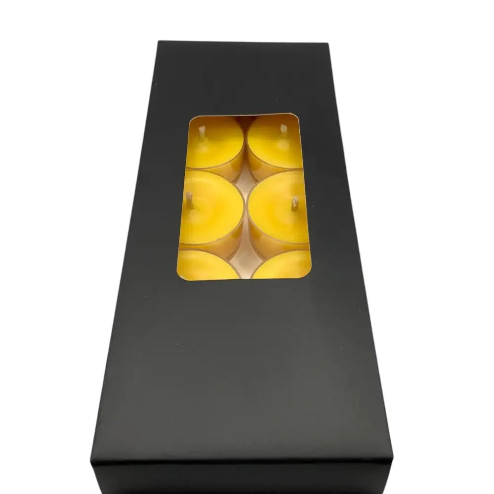 Box of Scented Tealight Candles showing yellow candles through a clear window, perfect for creating a calming and fragrant atmosphere.