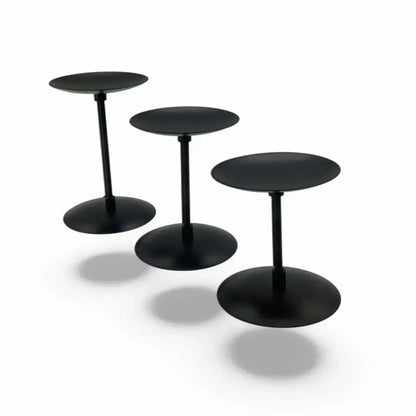 Three matte black wrought iron candle stands in varying heights, ideal for stylish home decor.