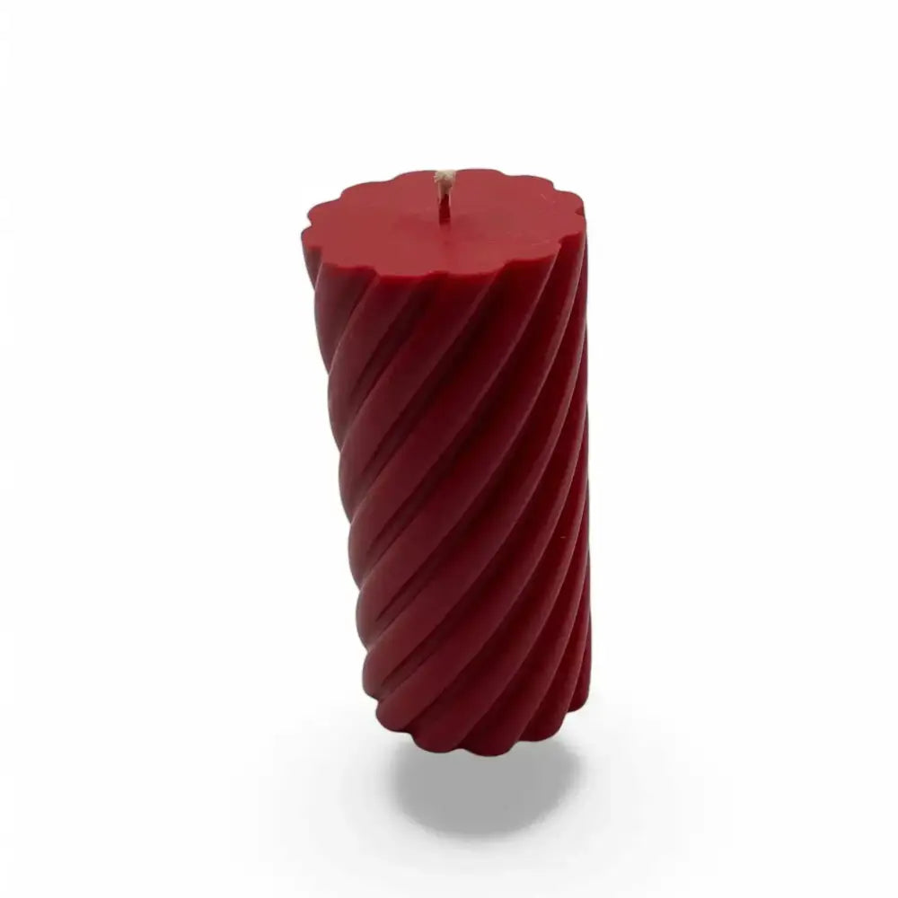 Vanilla cinnamon scented spiral pillar soy candle with elegant design.