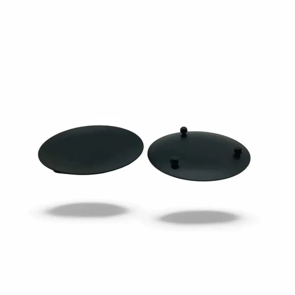 Round wrought iron candle holder with minimalist black design and small feet for stability.