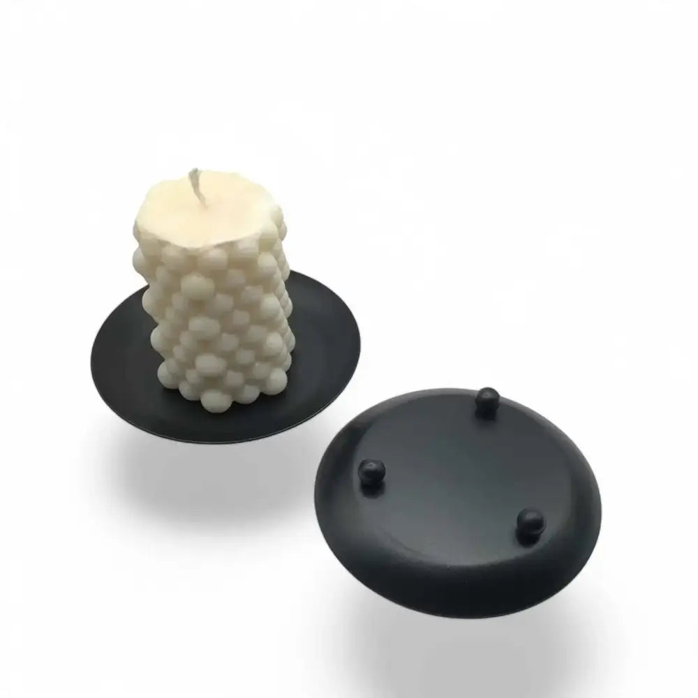 Round wrought iron candle holder in matte black finish with minimalist Nordic design.