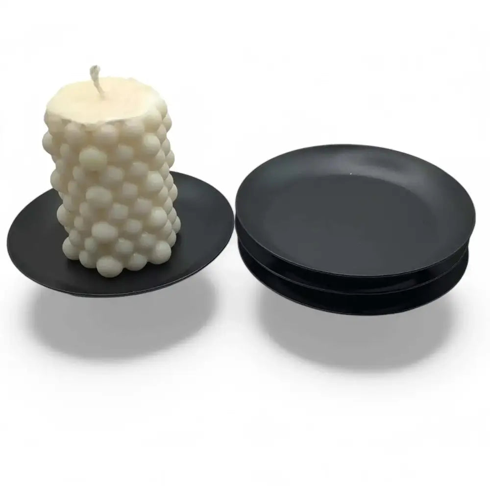 Round wrought iron candle holder in matte black finish, minimalist Nordic design, 10cm diameter, perfect for modern interiors, stability features.